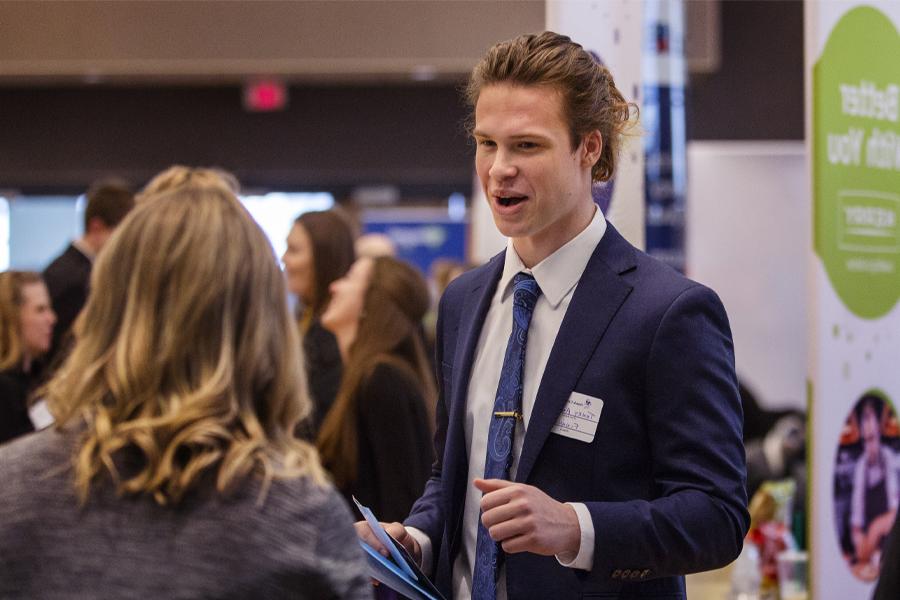 A student speaks with an employer at the career fair.